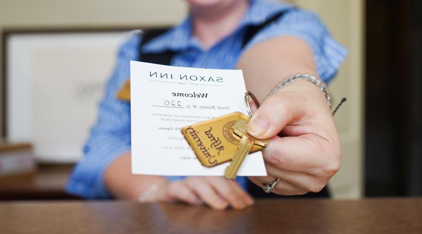 front desk handing over keys to a room